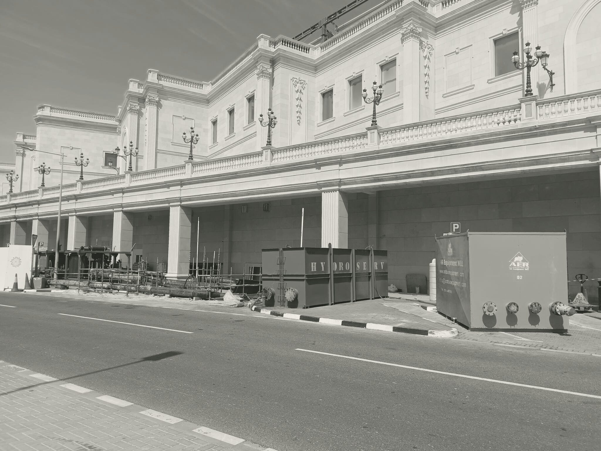 The colonnaded façade of Al Hazm Mall with plant on site